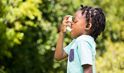 child using asthma inhaler