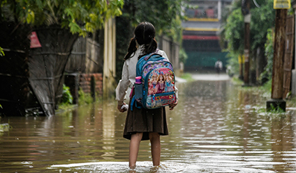 girl standing in flood waters