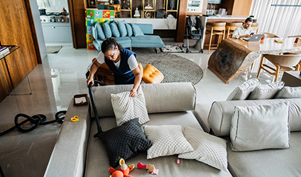 Photo of housekeeper sweeping couch