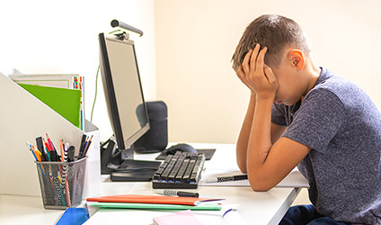 elementary student sitting at desk
