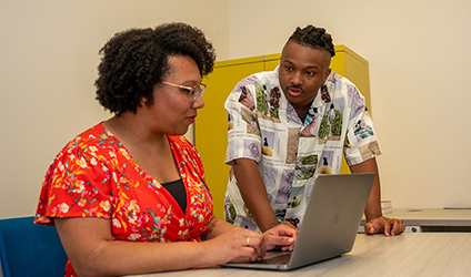 In the Social Cognition and Intergroup Processes (SCIP) lab, IPR graduate research assistant Jonathan Doriscar reviews a project with IPR psychologist Sylvia Perry.