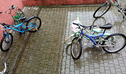 Bicycles parked on wet cobblestones in Kornalovichi, Ukraine.