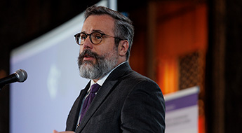 Andrew Papachristos at a podium