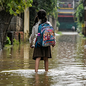 girl standing in a flooded street