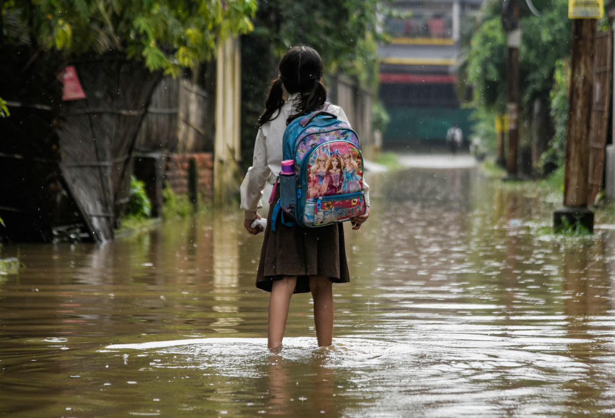 girl standing in flooded street