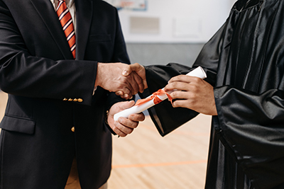 Two people shaking hands at graduation