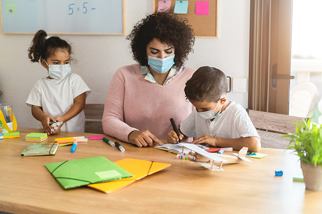 Childcare worker with young children