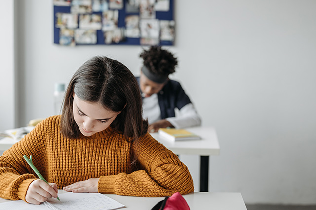 Two students writing 