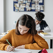 Two students writing 