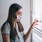 Teenage girl looking out the window 