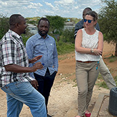 woman with a group of men near a water tank