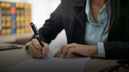 woman writing on a document