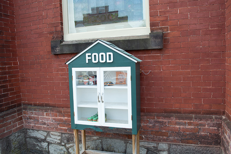 food pantry box in front of a brick wall