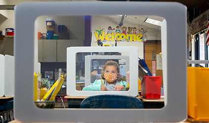 Girl with mask in classroom