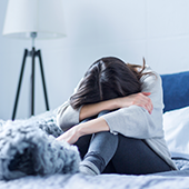 Depressed woman in bed