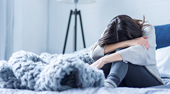 Depressed woman in bed