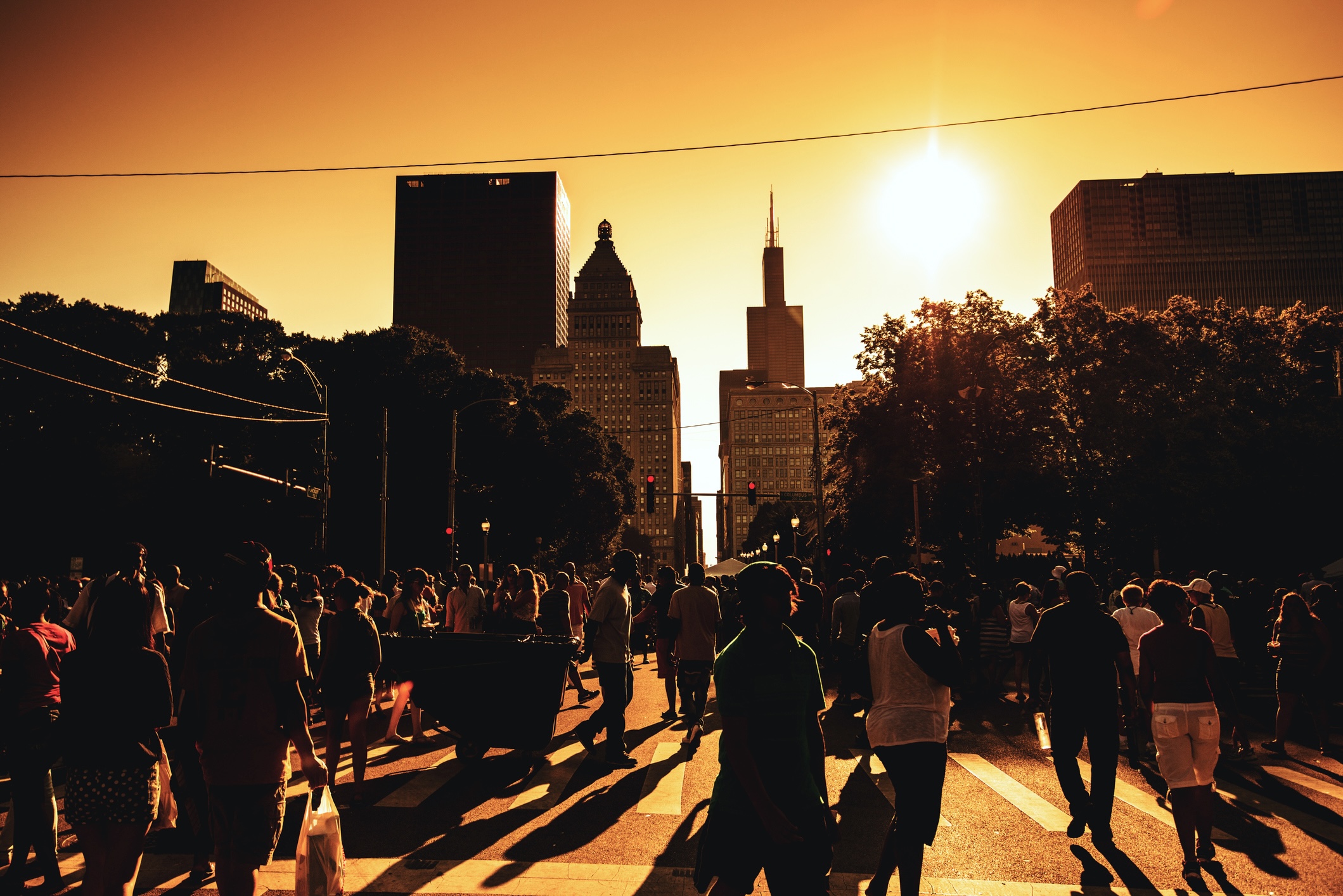 a crowded street in downtown Chicago on a hot summer day