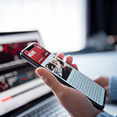 Image of woman scrolling on news site