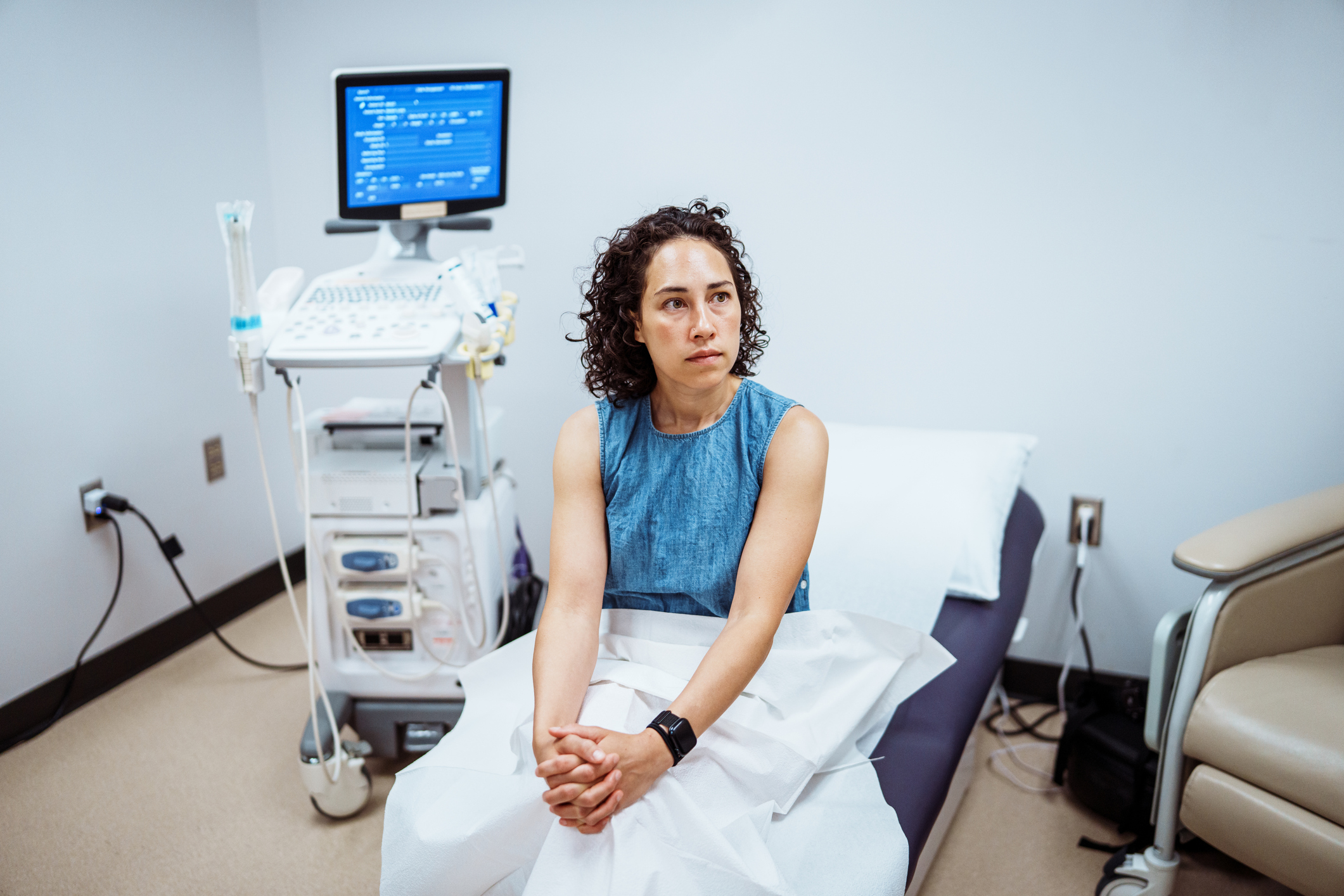 woman awaiting an ultrasound with her ob/gyn
