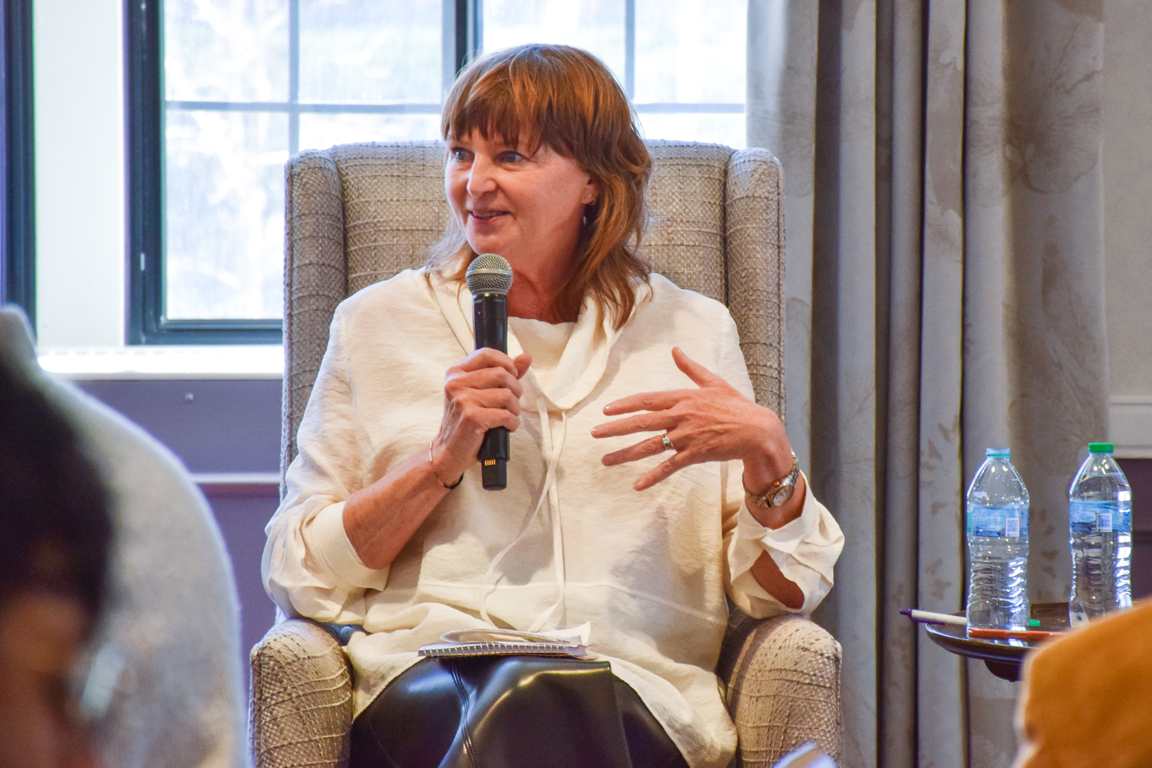 Panelist Louise Kiernan speaking into a microphone