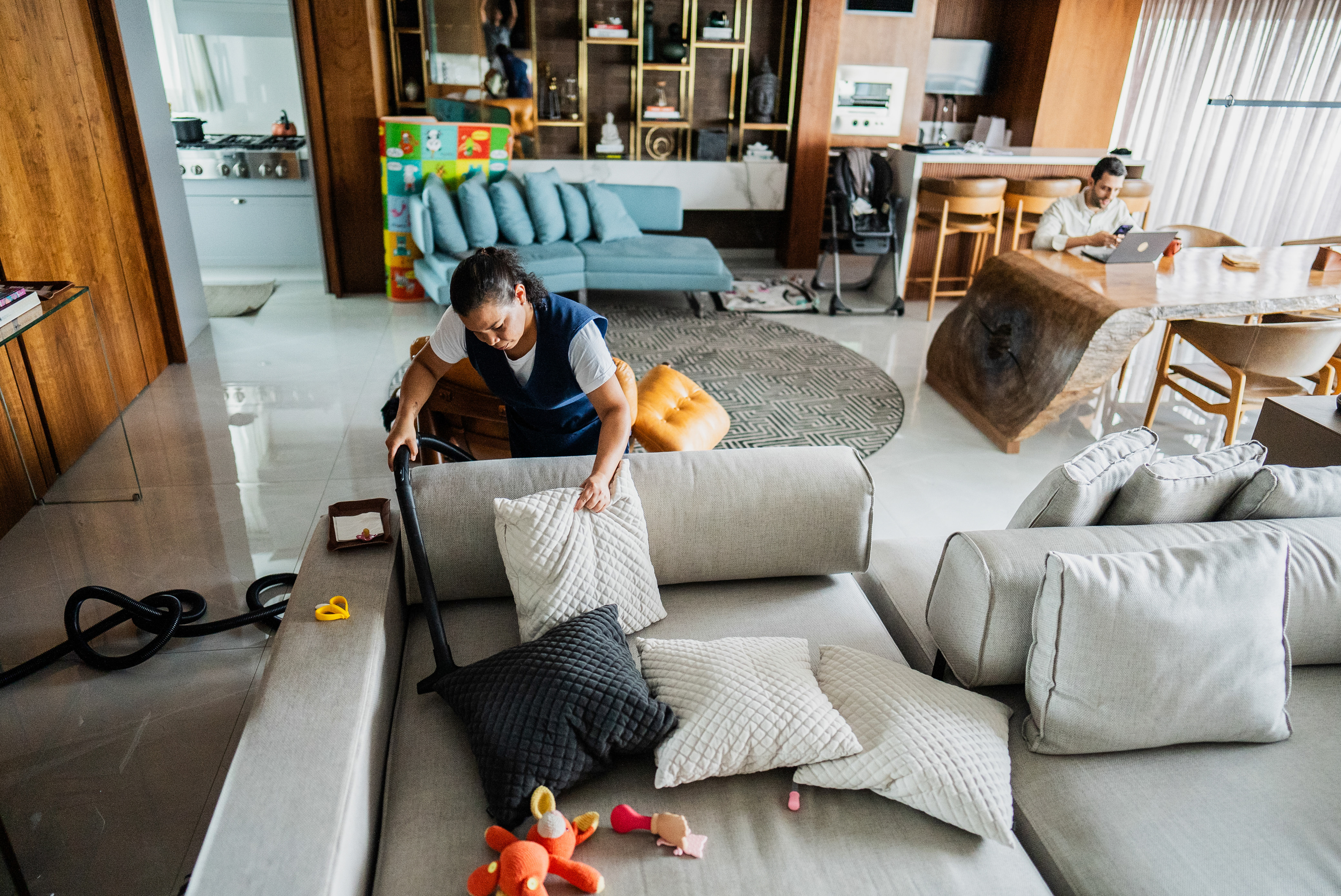 House cleaner working while a man works from home