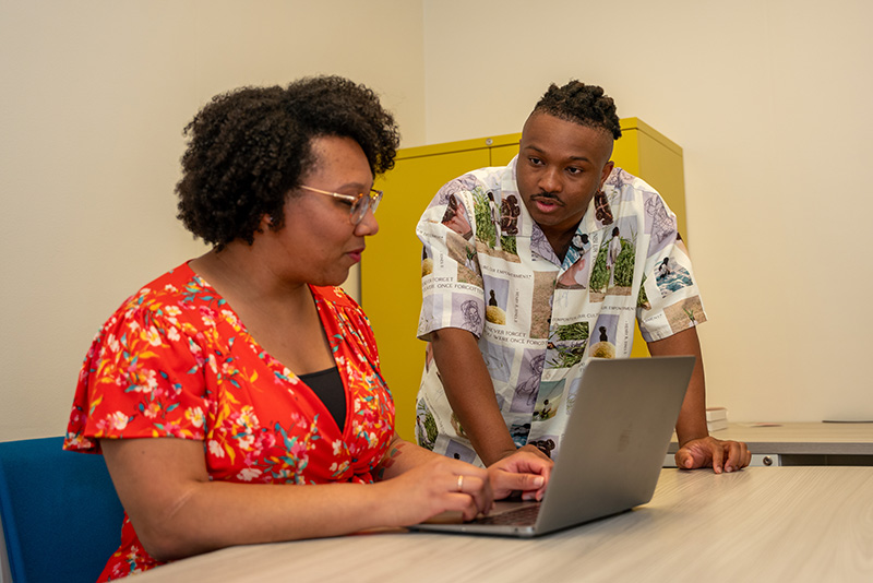 In the Social Cognition and Intergroup Processes (SCIP) lab, IPR graduate research assistant reviews a project with IPR psychologist Sylvia Perry.