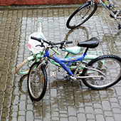 Bicycles stand on wet cobblestones in the rain in Kornalovichi village in western Ukraine.