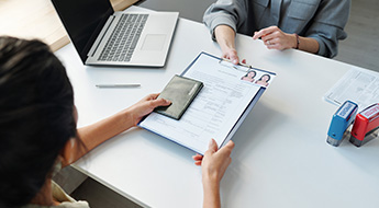 woman receiving a passport and visa application
